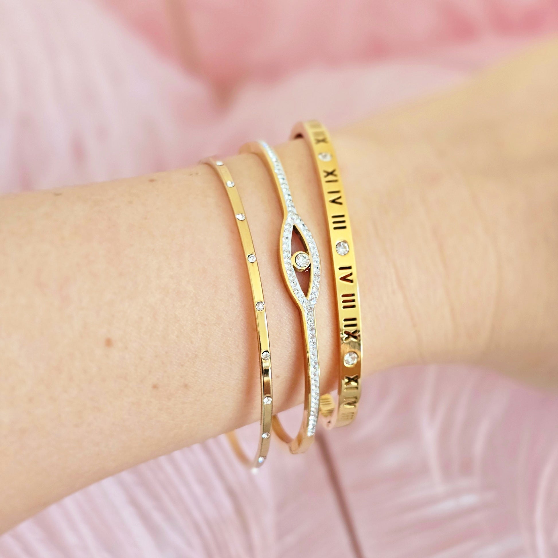 dainty gold thin bangles stack evil eye roman times