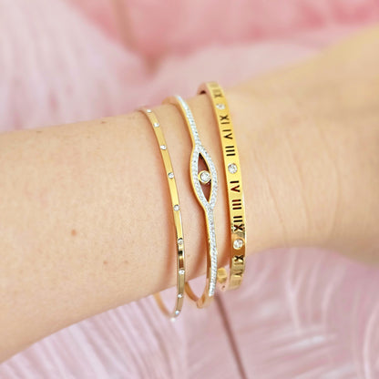 dainty gold thin bangles stack evil eye roman times