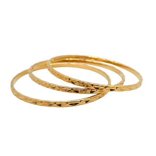 trio of gold bangles stack